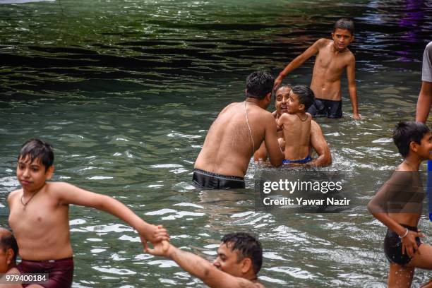 Kashmiri Pandit devotees take bath in the stream, during the annual Hindu festival of the Kheer Bhawani in its namesake temple on June 20, 2018 in...