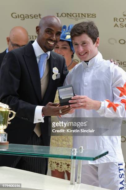 Sir Mo Farah presents The Queen Mary Stakes trophy to winning jockey Oisin Murphy on day 2 of Royal Ascot at Ascot Racecourse on June 20, 2018 in...