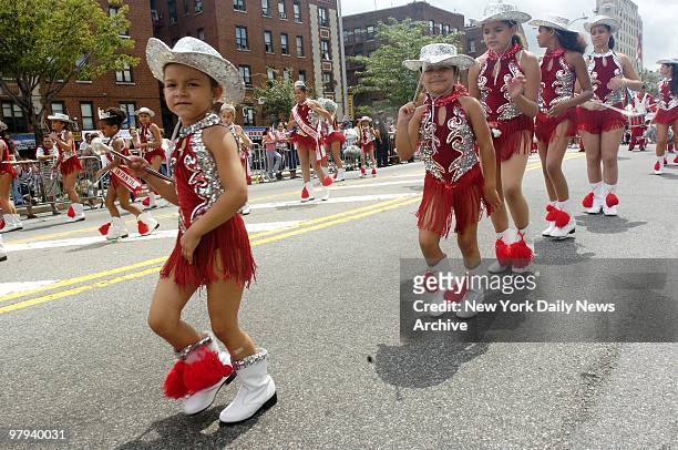 Young ladies move their tasseled boots to a Latin beat as they head up the Grand Concourse at the annual Puerto Rican Day Parade in the Bronx.