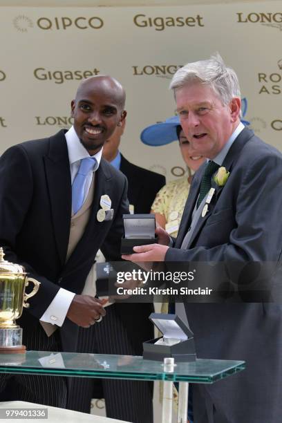 Sir Mo Farah presents the winners cup to winning trainer John Quinn after his horse Signora Cabello won the The Queen Mary Stakes on day 2 of Royal...