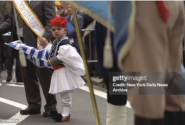 Youngster in a traditional costume is ready to join the annual Greek Independence Day Parade on Fifth Ave. On a fine day for marching with...