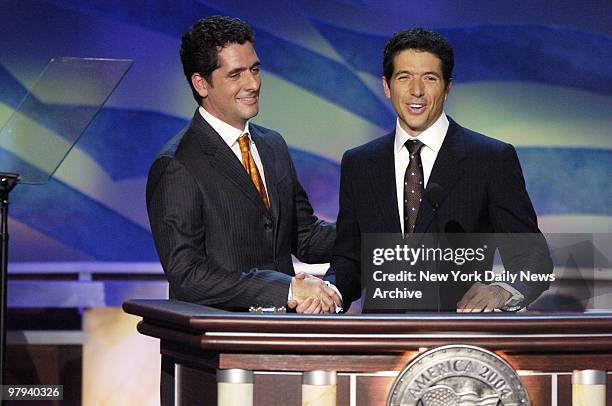 Chris and Andre Heinz, sons of presidential candidate John Kerry's wife, Teresa Heinz Kerry, shake hands as they address delegates on the last night...