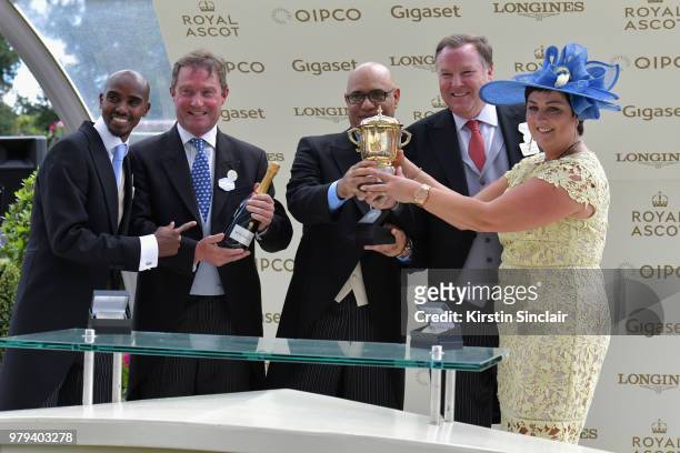 Sir Mo Farah presents the winners cup to winning breeder Dermot Farrington from Diomed Bloodstock Ltd after their horse Signora Cabello won the The...