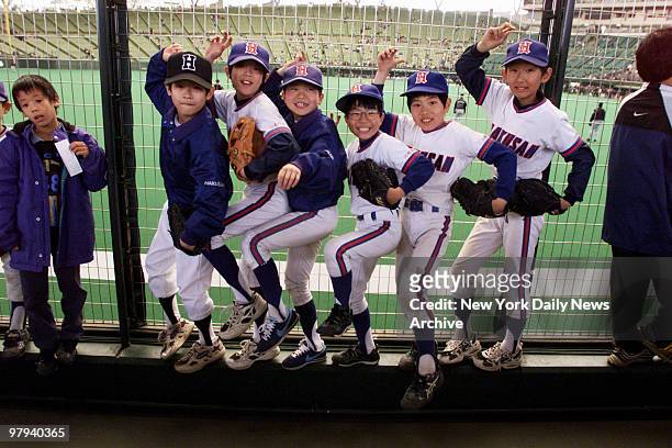 Youngsters are warmed up and ready for the game to start between the New York Mets and the Seibu Lions at the Seibu Dome. The Mets, who won the...