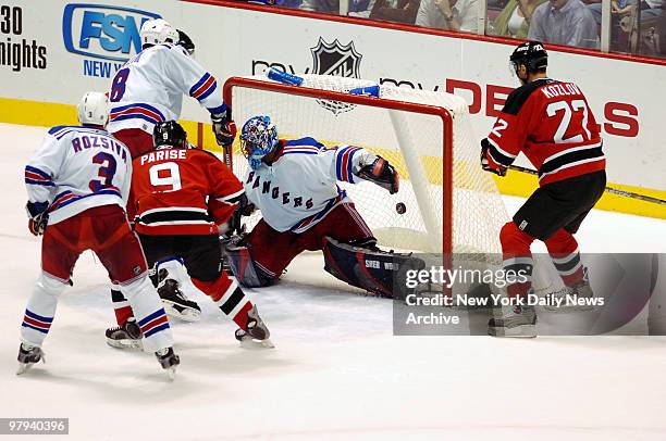 Puck hit by New Jersey Devils' Brian Gionta gets past New York Rangers' goalie Kevin Weekes during game at Continental Airlines Arena. The Rangers...