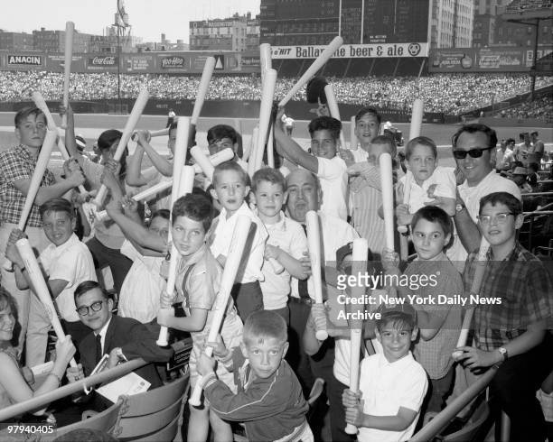 Youngsters holdup bats, compliments of the Yankee management, during Bay Day at Stadium. Crowd of 71,245 came out for largest major league attendance...