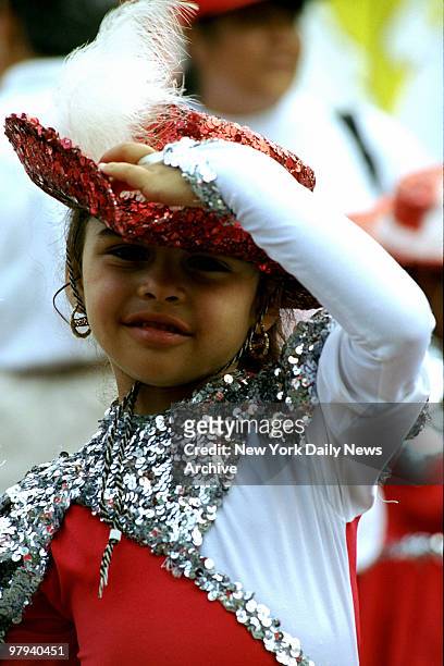 Puerto Rican parade on the Grand Concourse - baton-girl adjusts her hat during parade. Bronx.