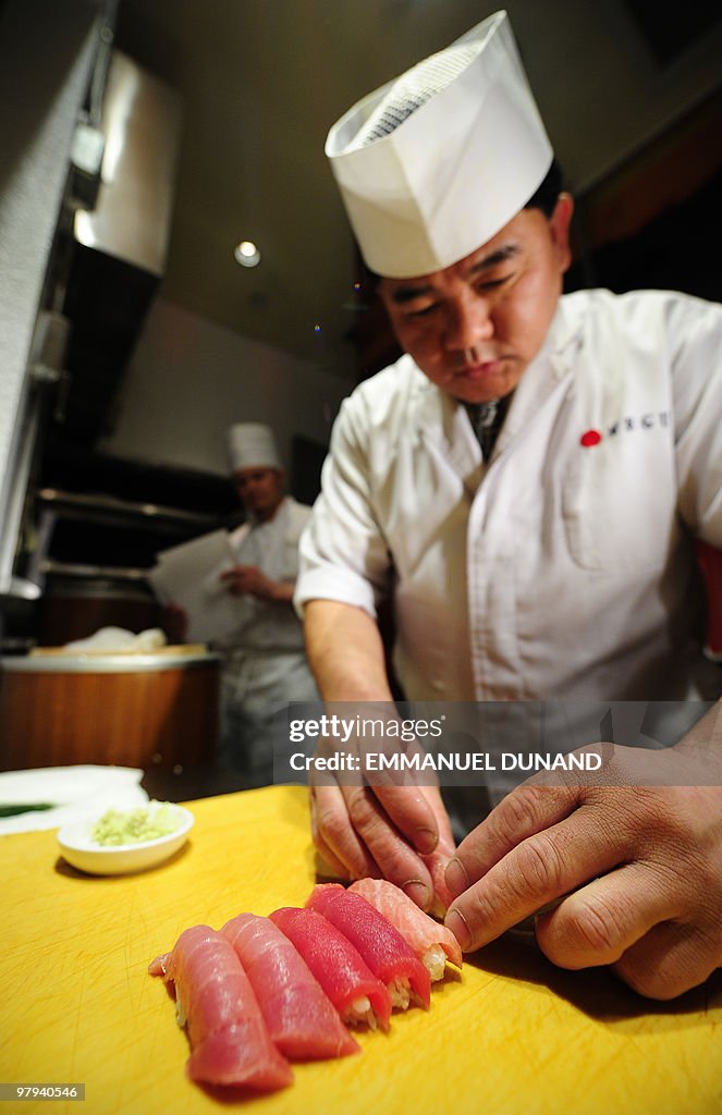 Sushi chef William Tawng prepares sushi