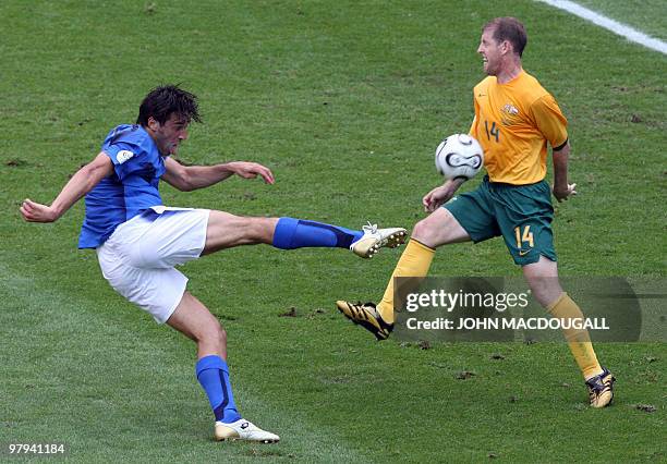 Australian defender Scott Chipperfield blocks a shot by Italian forward Luca Toni in the round of 16 World Cup 2006 football match between Italy and...