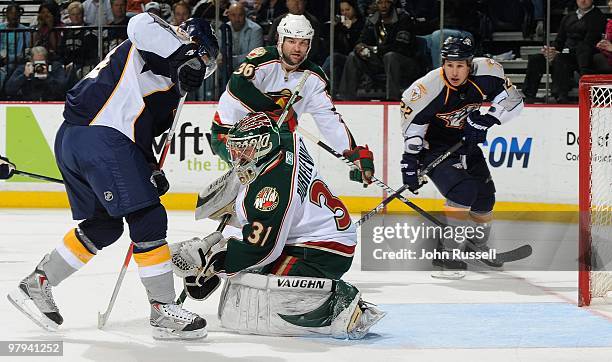 Josh Harding of the Minnesota Wild makes a glove save against the Nashville Predators on March 18, 2010 at the Bridgestone Arena in Nashville,...