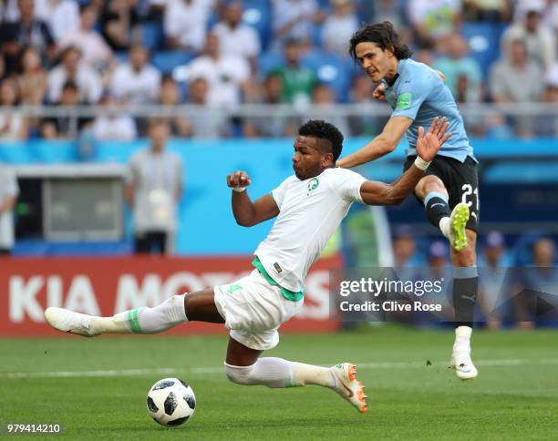 Edinson Cavani of Uruguay shoots past Ali Albulayhi of Saudi Arabia during the 2018 FIFA World Cup Russia group A match between Uruguay and Saudi...