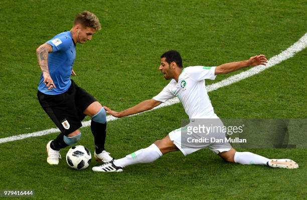 Taiseer Aljassam of Saudi Arabia gets injured while tackling Guillermo Varela during the 2018 FIFA World Cup Russia group A match between Uruguay and...