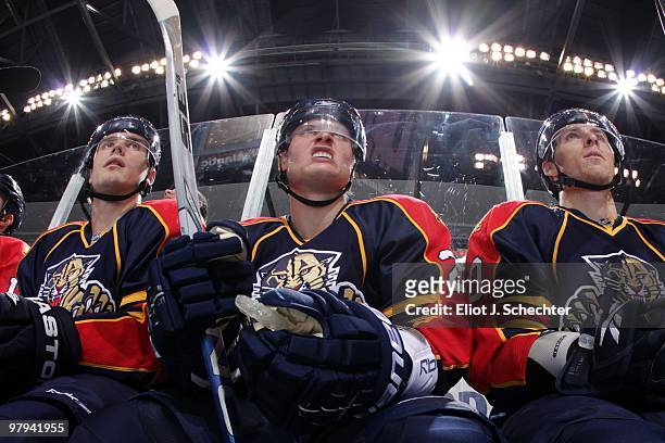 Kamil Kreps of the Florida Panthers sits on the bench between teammates Rostislav Olesz and David Booth against the Phoenix Coyotes at the...