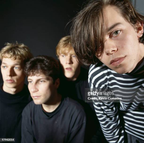 Posed group portrait of British band Ride. Left to right are Andy Bell, Steve Queralt, Laurence Colbert and Mark Gardener circa 1990.