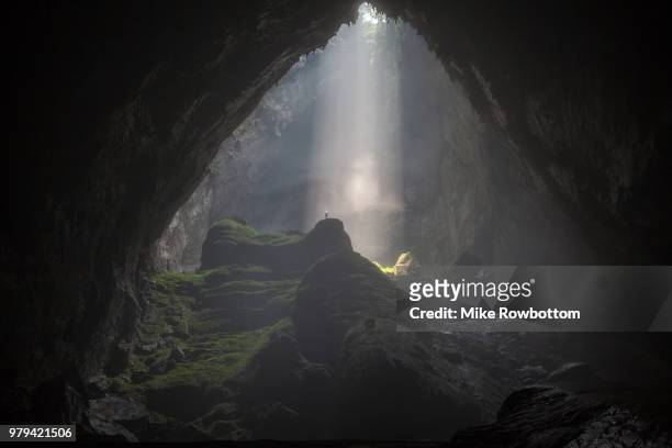 sunbeam inside dark son doong cave in phong nha-ke bang national park, quang binh province, vietnam - cave stock pictures, royalty-free photos & images
