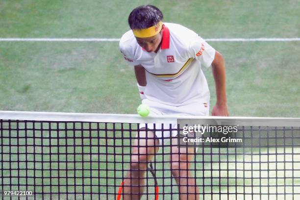 Kei Nishikori of Japan watches his stop ball fly over the net during his round of 16 match against Karen Khachanov of Russia on day 3 of the Gerry...