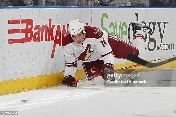 Taylor Pyatt of the Phoenix Coyotes falls to the ice while chasing a puck behind the Florida Panthers net on March 18, 2010 at the BankAtlantic...