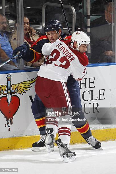 Mathieu Schneider of the Phoenix Coyotes checks Cory Stillman of the Florida Panthers behind the net on March 18, 2010 at the BankAtlantic Center in...
