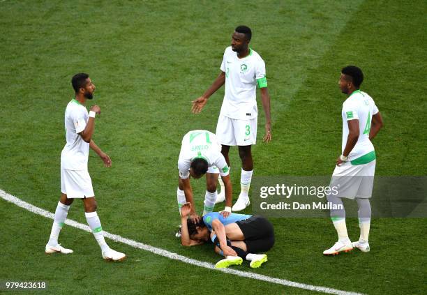 Abdullah Otayf of Saudi Arabia checks on Edinson Cavani of Uruguay who goes down injured during the 2018 FIFA World Cup Russia group A match between...