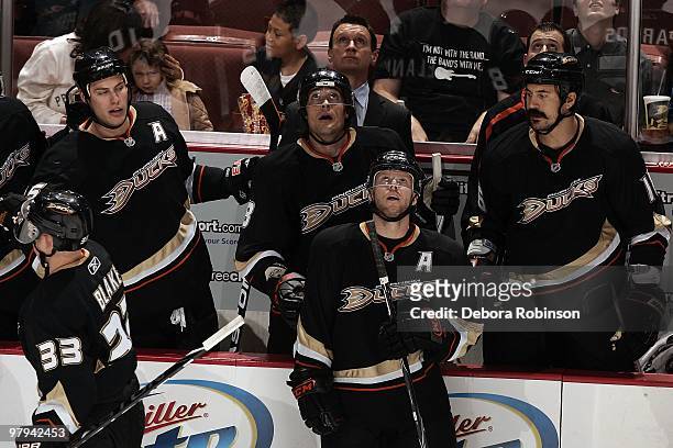 Teemu Selanne of the Anaheim Ducks and teammates on the bench look to the jumbotron for a replay of a play during the game against the Colorado...