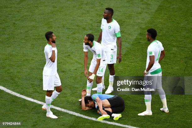 Abdullah Otayf of Saudi Arabia checks on Edinson Cavani of Uruguay who goes down injured during the 2018 FIFA World Cup Russia group A match between...