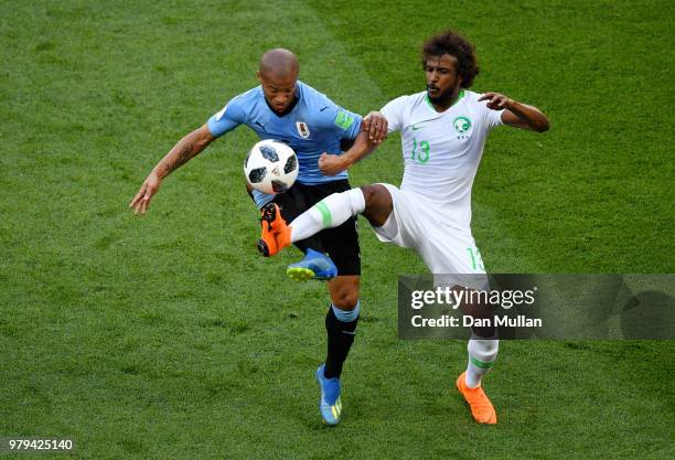 Carlos Sanchez of Uruguay challenge for the ball with Yasser Alshahrani of Saudi Arabia during the 2018 FIFA World Cup Russia group A match between...