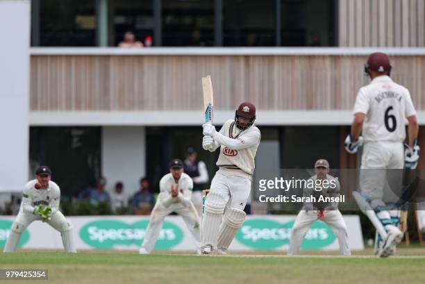 Ryan Patel of Surrey hits out in front of the new Guildford Cricket Club pavilion during day 1 of the Specsavers County Championship Division One...