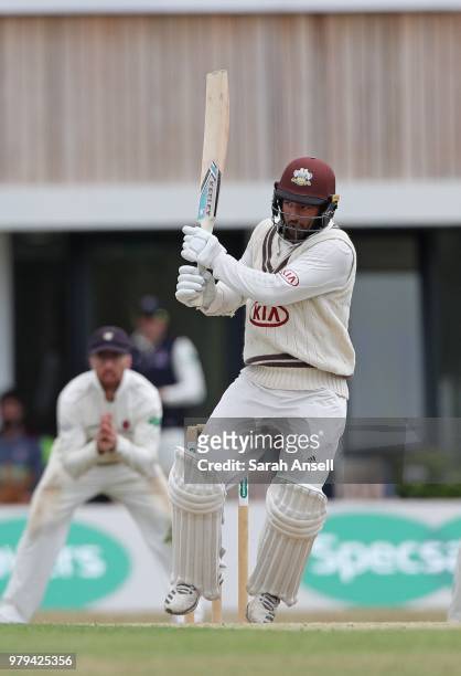 Ryan Patel of Surrey hits out in front of the new Guildford Cricket Club pavilion during day 1 of the Specsavers County Championship Division One...