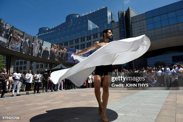 Syrian dancer and choreographer Ahmad Joudeh performs on the occasion of World Refugee Day at the Simone Veil Esplanade in front of the European...