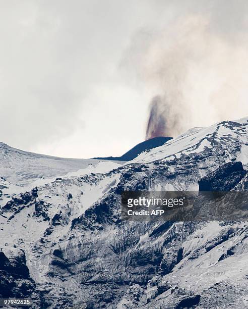 Smoke rises and lava spews from the site of a volcanic eruption behind the Eyjafjallajoekull glacier, some125 kilometres east of Iceland's capital...