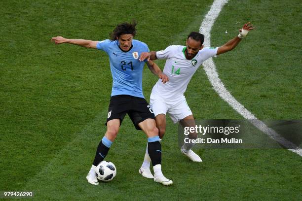Edinson Cavani of Uruguay battles for possession with Abdullah Otayf of Saudi Arabia during the 2018 FIFA World Cup Russia group A match between...