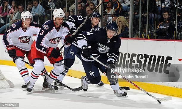 Dustin Boyd of the Nashville Predators skates against Marc Methot of the Columbus Blue Jackets on March 20, 2010 at the Bridgestone Arena in...