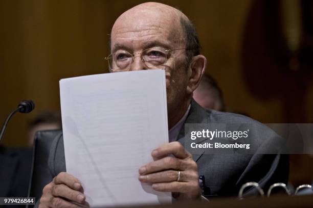 Wilbur Ross, U.S. Commerce secretary, holds a stack of paper during a Senate Finance Committee hearing on current and and proposed tariff actions in...