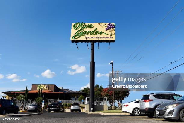 Vehicles sit parked outside a Darden Restaurants Inc. Olive Garden location in San Antonio, Texas, U.S., on Tuesday, June 12, 2018. Darden...