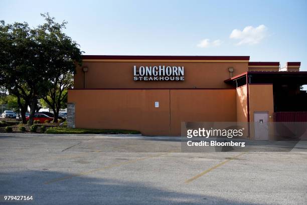 Signage is displayed at a Darden Restaurants Inc. Longhorn Steakhouse location in San Antonio, Texas, U.S., on Monday, June 11, 2018. Darden...