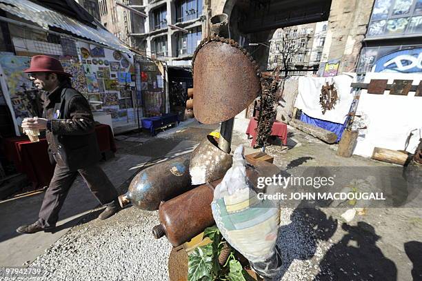 Man walks past a sculpture by Italian artist Luca Ciavarella at the Kunsthaus Tacheles artists' colony's outdoor gallery in Berlin's mitte district...