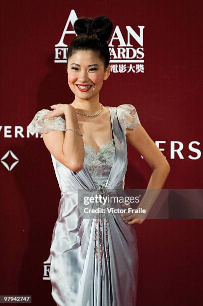 Chinese television presenter Angela Chow poses on the red carpet for the 4th Asian Film Awards ceremony at the Convention and Exhibition Centre on...