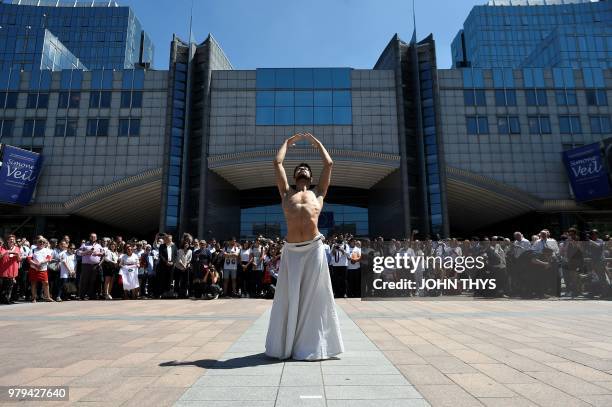 Syrian dancer and choreographer Ahmad Joudeh performs on the occasion of World Refugee Day at the Simone Veil Esplanade in front of the European...