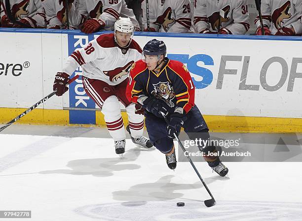 David Booth of the Florida Panthers skates with the puck while being pursued by Vernon Fiddler of the Phoenix Coyotes on March 18, 2010 at the...