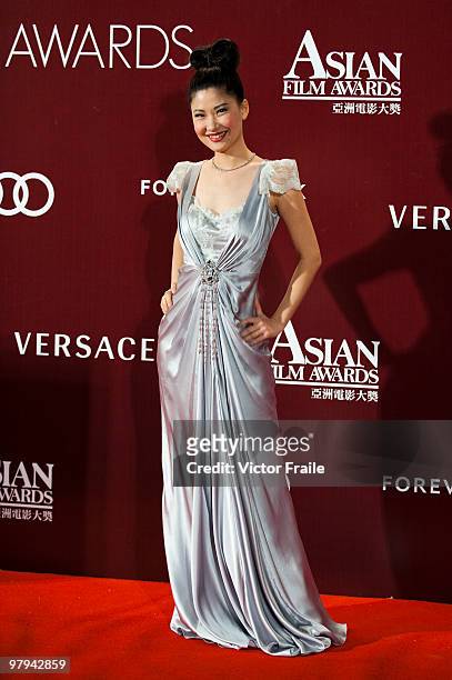 Chinese television presenter Angela Chow poses on the red carpet for the 4th Asian Film Awards ceremony at the Convention and Exhibition Centre on...