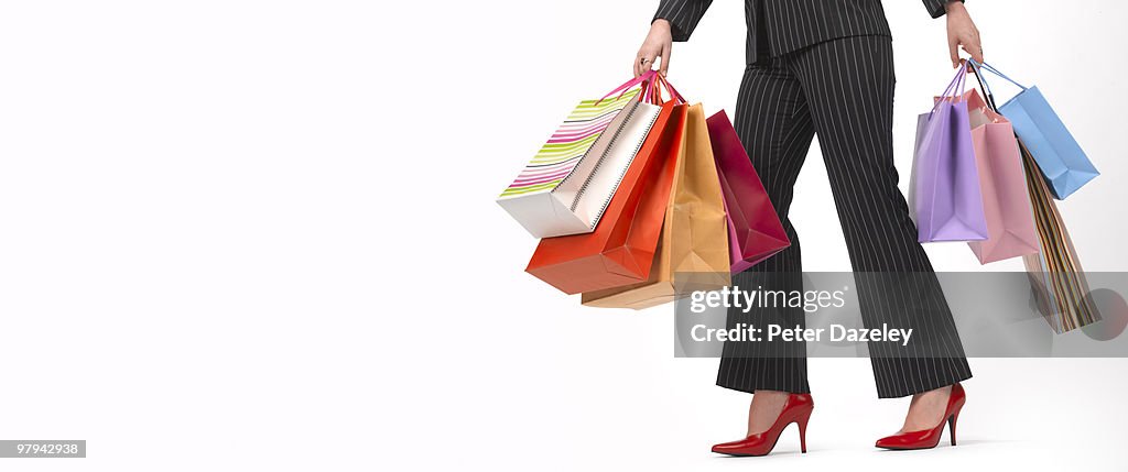 Shopaholic teenager with shopping bags