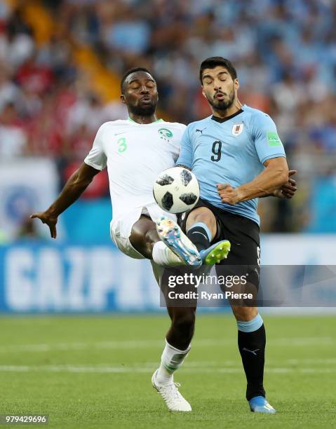 Osama Hawsawi of Saudi Arabia battles for possession with Luis Suarez of Uruguay during the 2018 FIFA World Cup Russia group A match between Uruguay...