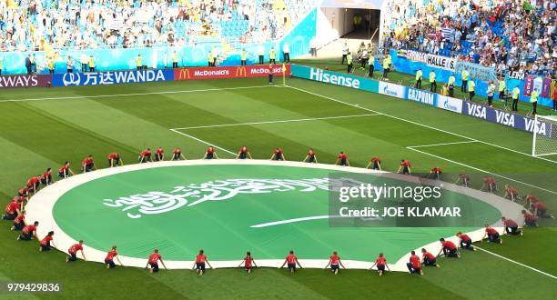 Saudi Arabia's giant flag is seen on the pitch before the start of the Russia 2018 World Cup Group A football match between Uruguay and Saudi Arabia...