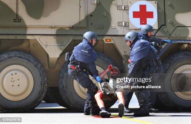 June 2018, Penzing, Germany: In a simulated scenario, special police forces carry a gunshot wounded victim on the air base. Herrmann attended the...