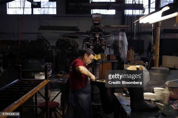 Worker places a sole on a leather boot at the Dehner Co. Factory in Omaha, Nebraska, U.S., on Tuesday, June 5, 2018. Markit is scheduled to release...