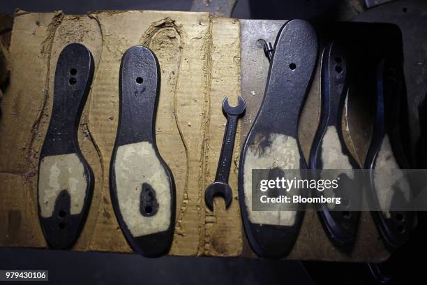 Wooden shoe sole patterns sit on a table at the Dehner Co. Boot factory in Omaha, Nebraska, U.S., on Tuesday, June 5, 2018. Markit is scheduled to...