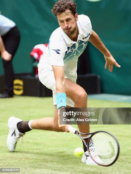 Robin Haase of Netherlands plays a backhand to Roberto Bautista Agut of Spain during their round of 16 match on day 3 of the Gerry Weber Open at...