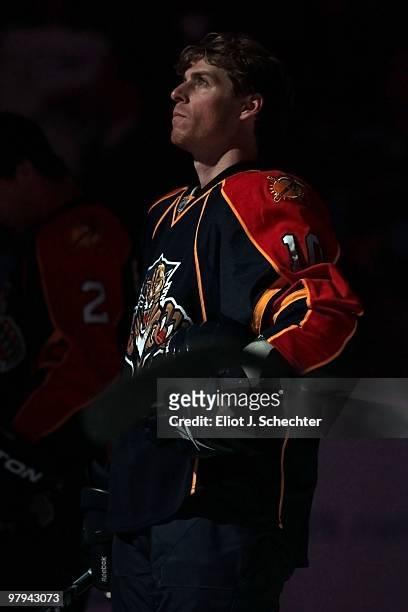 David Booth of the Florida Panthers stands on the ice for the national anthem prior to the start of the game against the Phoenix Coyotes at the...