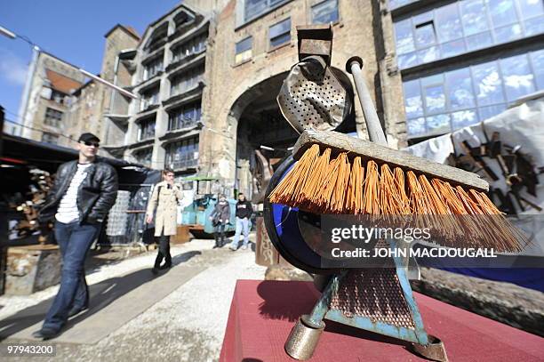 Visitors walk past a sculpture by Italian artist Luca Ciavarella at the Kunsthaus Tacheles artists' colony's outdoor gallery in Berlin's mitte...
