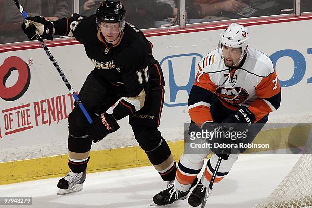 Corey Perry of the Anaheim Ducks defends behind the net against Trent Hunter of the New York Islanders during the game on March 19, 2010 at Honda...